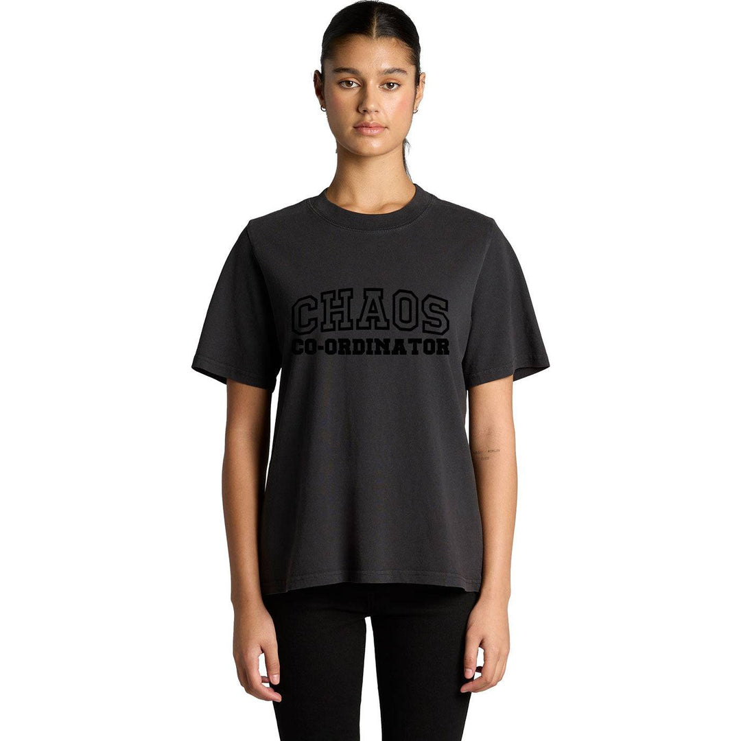 Woman wearing a black Chaos Co-Ordinator Tee with bold black lettering, styled for a casual equestrian-inspired look.