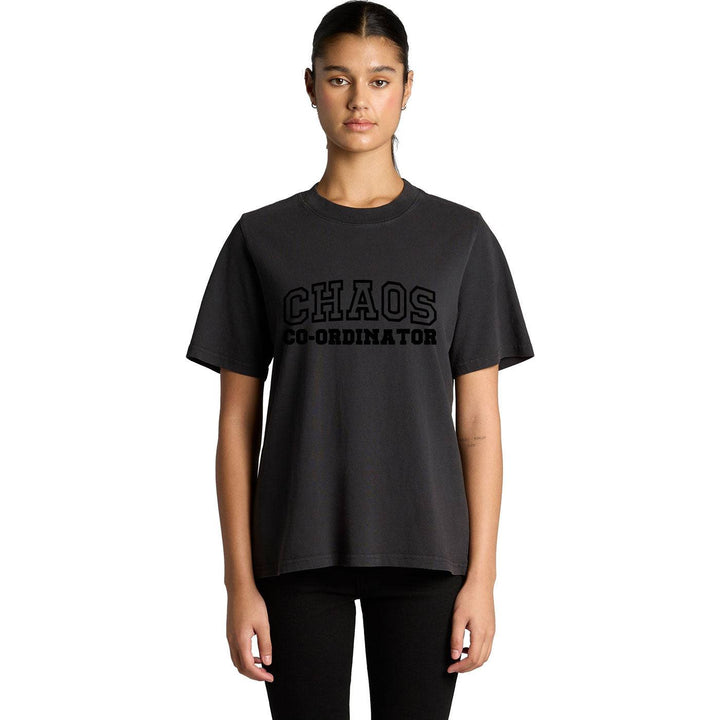 Woman wearing a black Chaos Co-Ordinator Tee with bold black lettering, styled for a casual equestrian-inspired look.