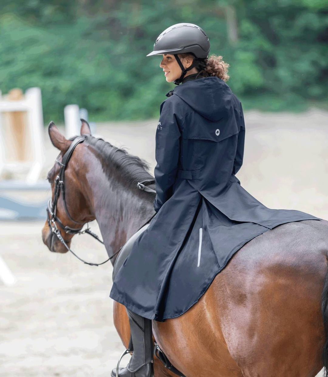 Back view of the ELT Fehmarn Long Riding Raincoat with its split design for saddle coverage and adjustable waist for a tailored fit.
