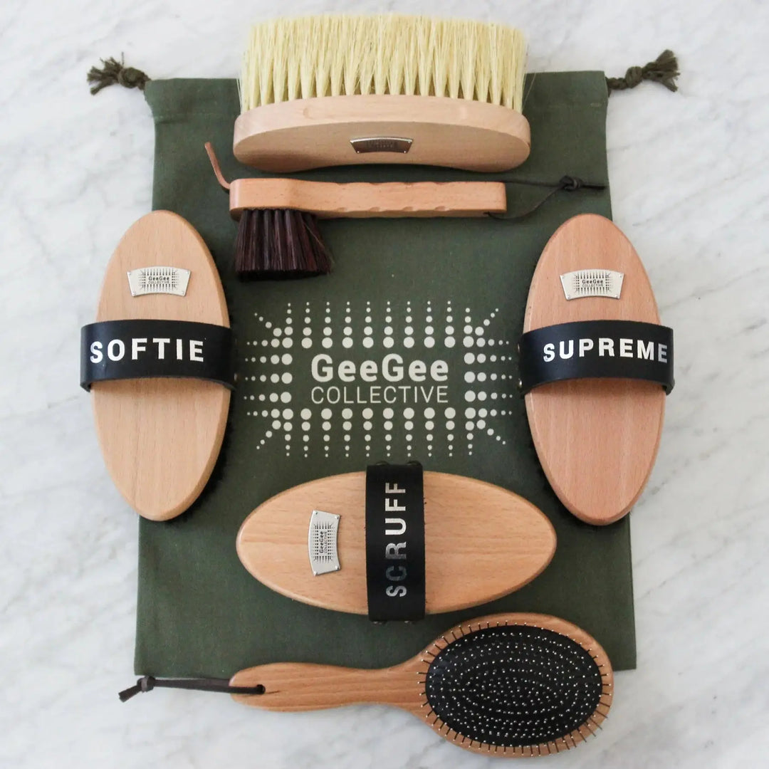 Complete Groom-Tastic Brush Kit with multiple wooden horse brushes, including soft, medium, and hard bristles, on a green GeeGee Collective bag.