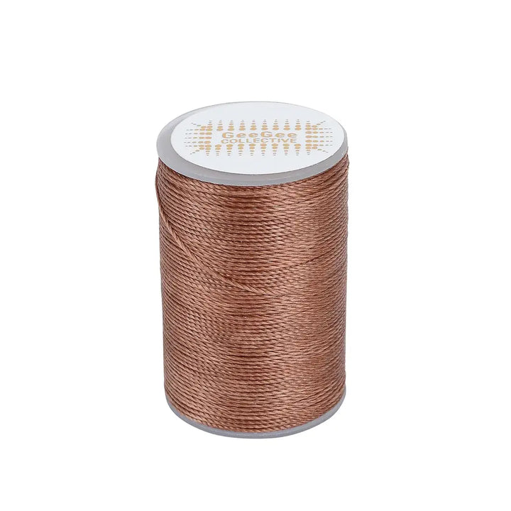 Brown horse plaiting thread spool designed for durable and flawless plaits. Perfect for equestrian grooming with a waxed texture for grip.