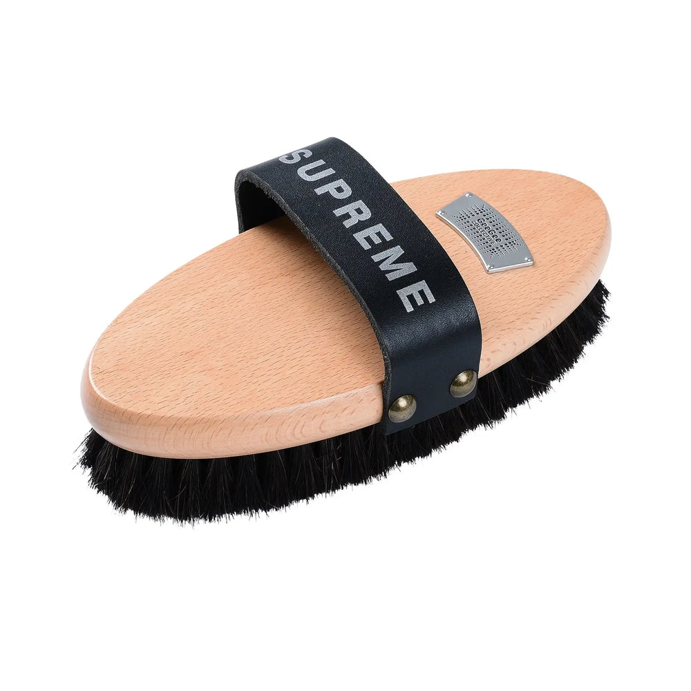 Supreme horse brush with black bristles, ergonomic wooden handle, and a durable strap for comfortable grooming.