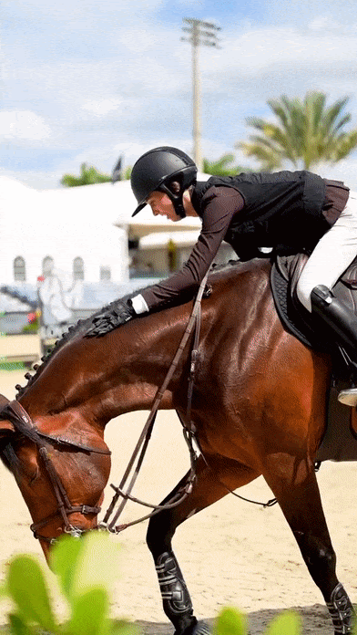 Equestrian rider wearing Kunkle Riding Gloves while riding a horse, demonstrating their functionality and comfort in outdoor recreation.