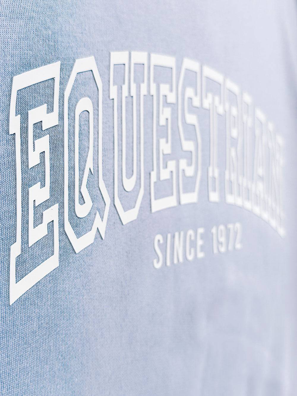 Side view of light blue Limited Edition Equestrian Sweatshirt highlighting the detailed embossed 'Equestrian Since 1972' text.