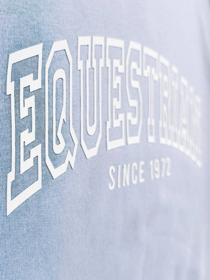 Side view of light blue Limited Edition Equestrian Sweatshirt highlighting the detailed embossed 'Equestrian Since 1972' text.