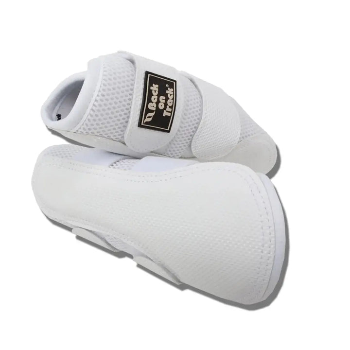 Close-up of white 3D Mesh Brushing Boots showcasing breathable material and secure strap system for equestrian use.