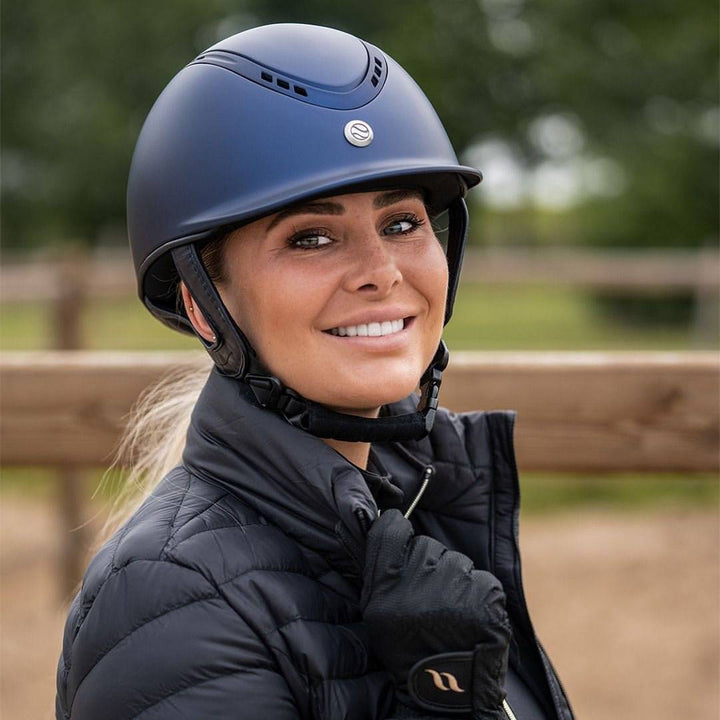 Rider wearing the Back On Track EQ3 Pardus Smooth Horse Riding Helmet with MIPS in blue, showcasing its stylish and comfortable fit.