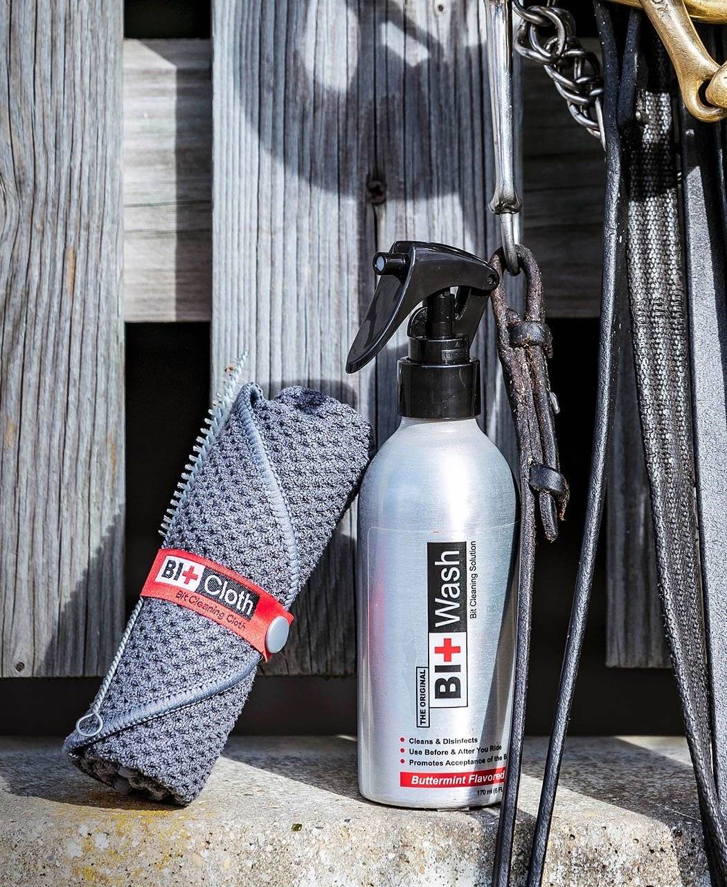 Bit Wash Cleaning Kit displayed with a spray bottle, cleaning cloth, and horse tack, ideal for equestrian grooming and bit care.