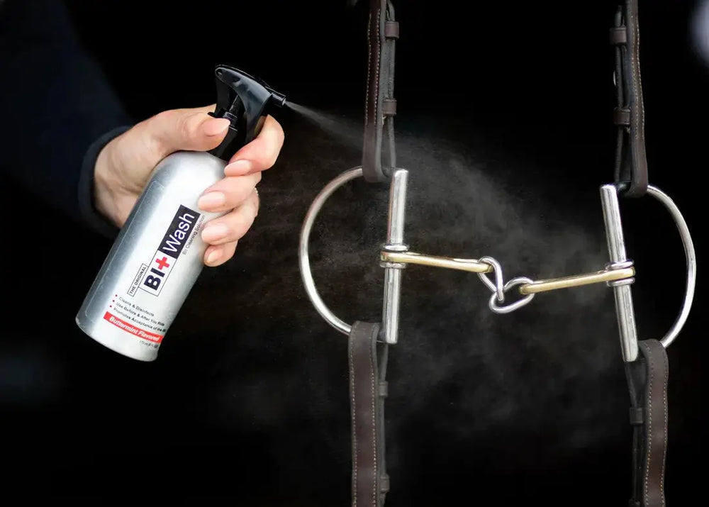 Bit Wash spray being applied to a horse bit, showcasing its cleaning and disinfecting properties for equestrian tack maintenance.