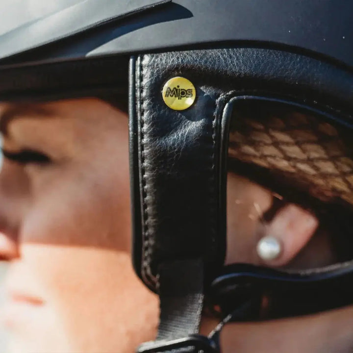 Close-up of the MIPS logo on the Back On Track EQ3 Lynx Smooth Riding Helmet, emphasizing its advanced safety technology.