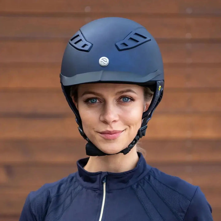 Front view of a rider wearing the Back On Track EQ3 Lynx Smooth Riding Helmet with MIPS, showcasing its ergonomic fit and style.