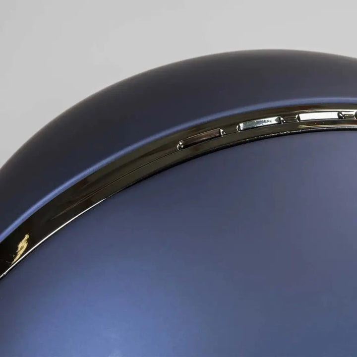 Detailed view of the Back On Track EQ3 Pardus Smooth Horse Riding Helmet with MIPS in blue, focusing on the metallic trim and smooth finish.