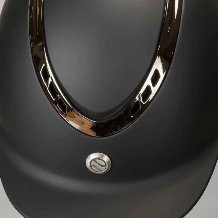 Close-up of the Back On Track EQ3 Pardus Smooth Horse Riding Helmet with MIPS in black, highlighting the metallic trim and ventilation details.