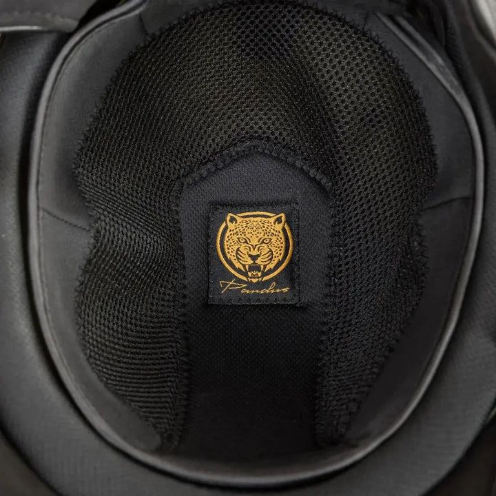 Interior view of the Back On Track EQ3 Pardus Smooth with Sparkle riding helmet, showcasing breathable black mesh lining and a gold Pardus logo.