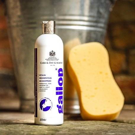 Gallop Stain Removing Shampoo bottle displayed with a yellow sponge and a metal bucket, perfect for horse grooming and stain removal.