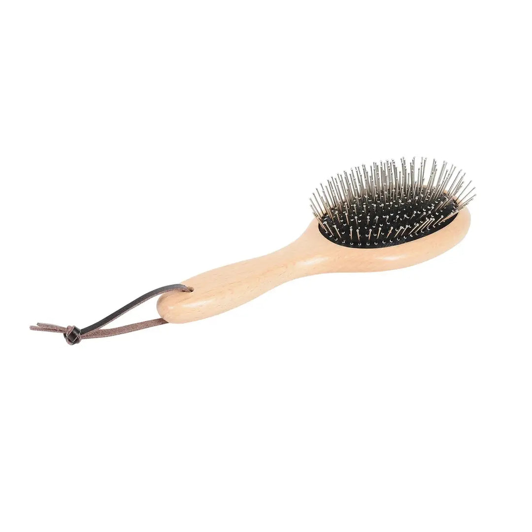 Close-up of the metal pins on the wooden pin brush from the Ultimate Brush Kit for horse grooming.