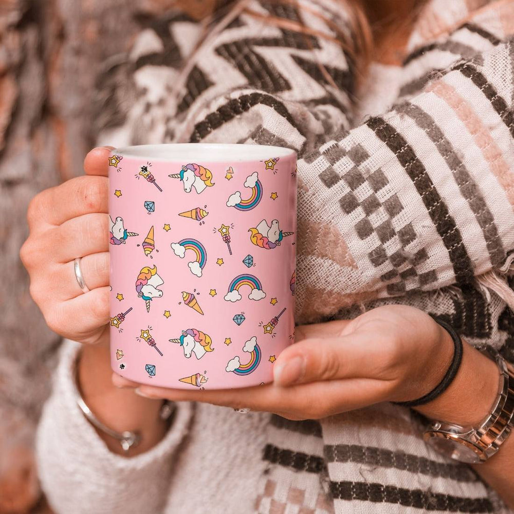 Person holding a Magical Unicorn Mug with a pink background and whimsical unicorn-themed design. Ideal for hot and cold beverages.