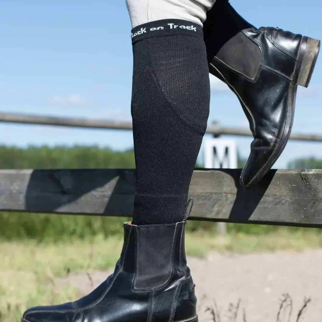 Nikki Riding Socks worn with horse riding boots, showcasing their sleek fit and therapeutic benefits for equestrian activities.