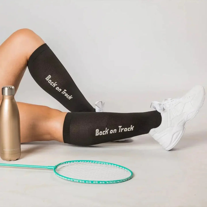 Noah Riding Socks paired with white sneakers and sports gear, ideal for training and outdoor activities with therapeutic benefits.