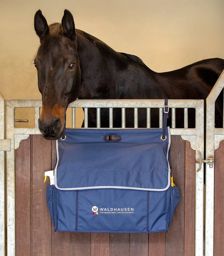 Closed Waldhausen Stable Organiser Bag securely attached to a stable door, providing a neat storage solution for equestrian gear.