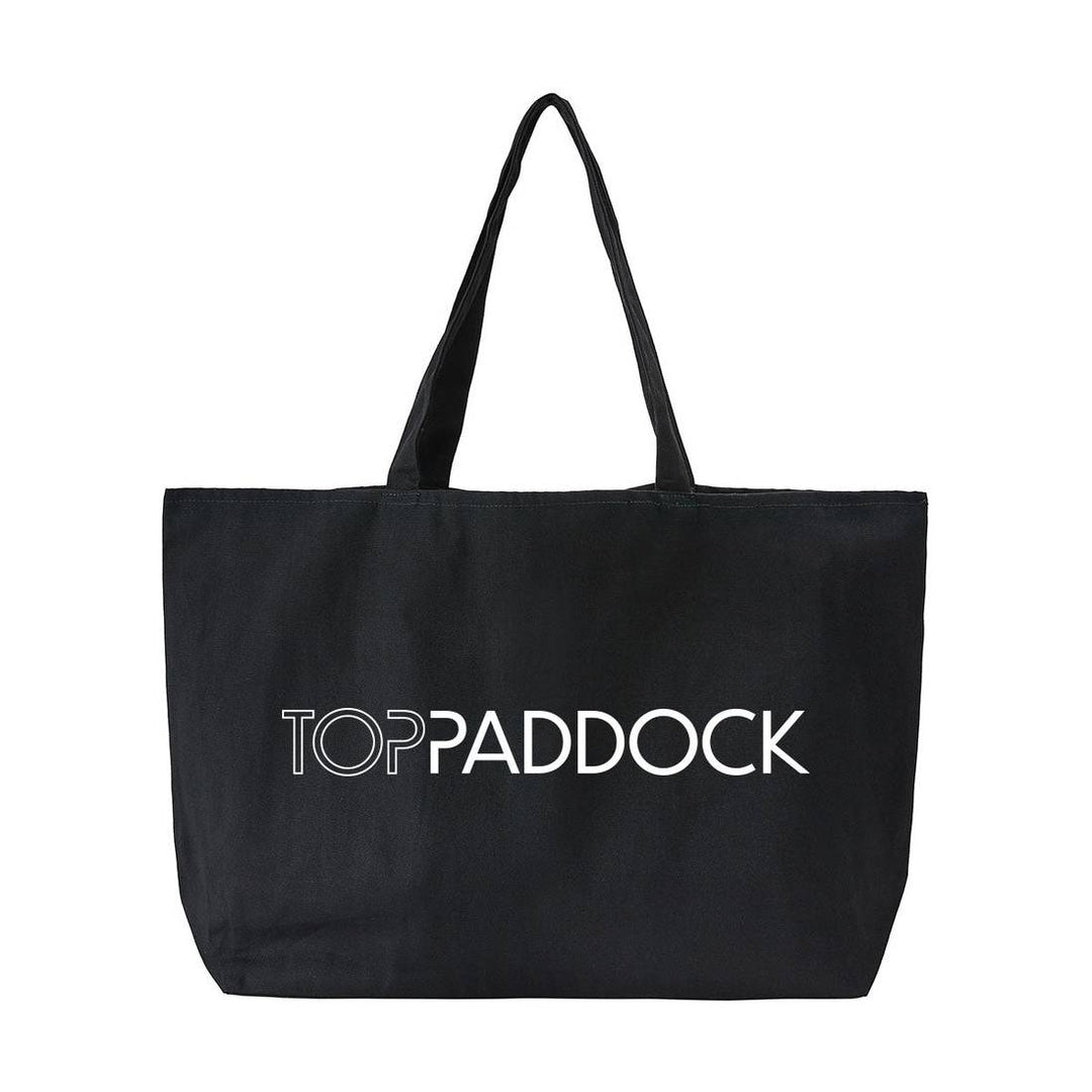 Top Paddock Equestrian Oversized Tote Bag in black with white logo, featuring durable handles and a spacious design for carrying essentials.