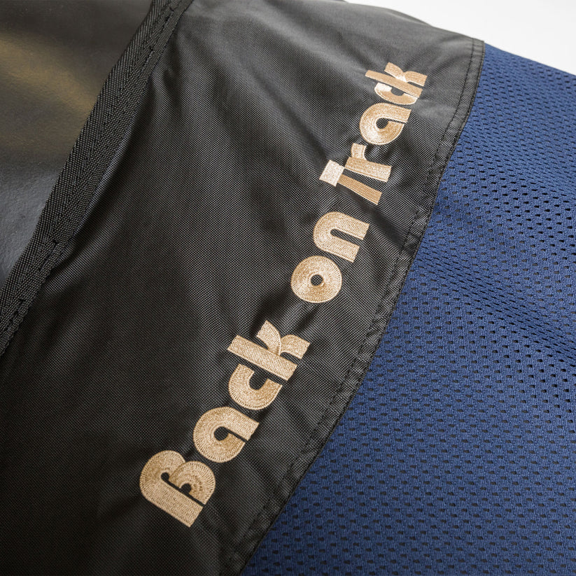 Close-up of Back On Track branding on the Deluxe Royal Horse Mesh Rug, showcasing premium stitching and design.