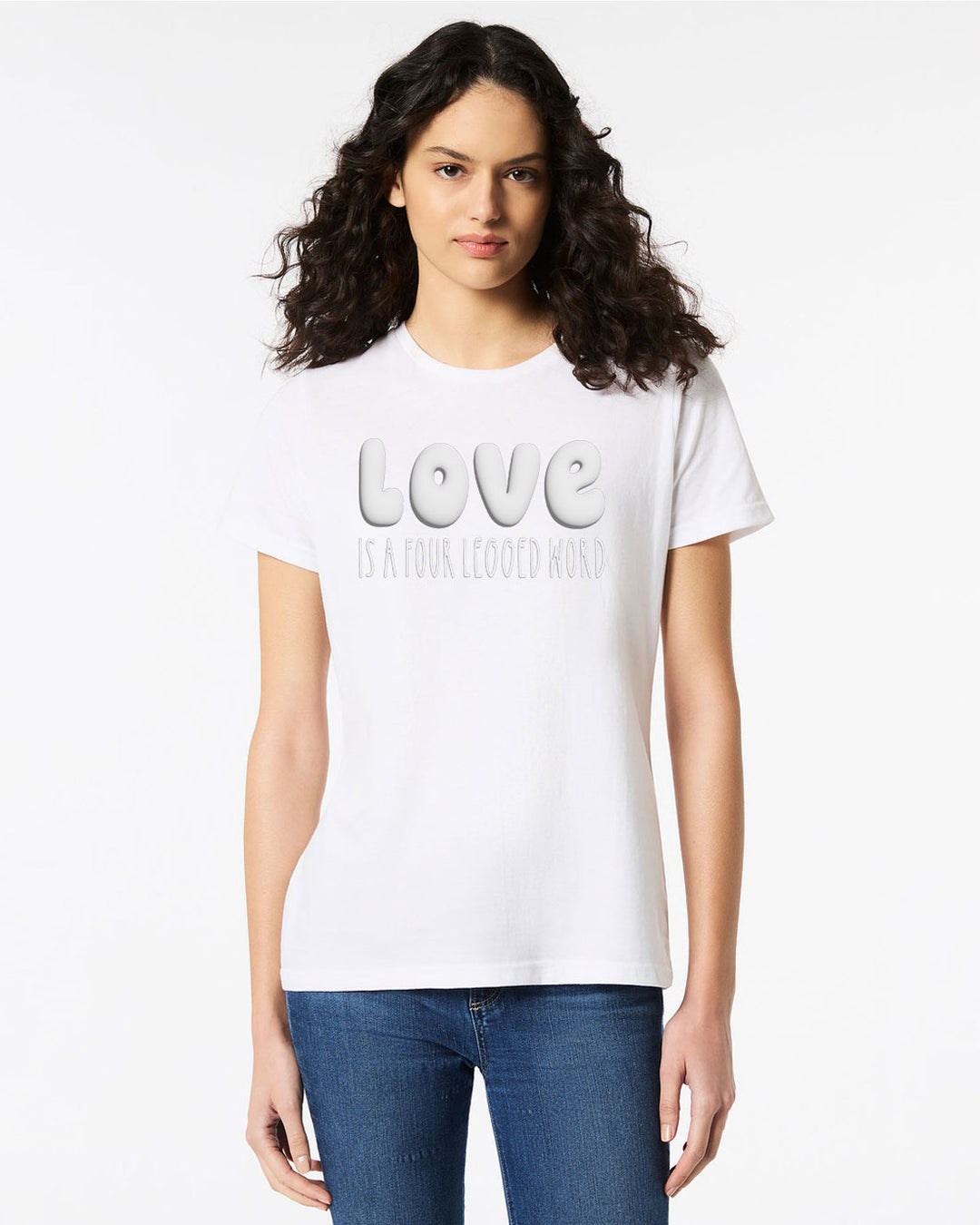 Model wearing the Love Is A Four Legged Word Tee in white with subtle puffy print text, paired with jeans for a casual look.