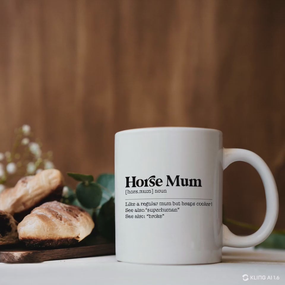 White ceramic Horse Mum Mug with a humorous equestrian quote, placed on a wooden table beside pastries and greenery. Perfect equestrian gift.