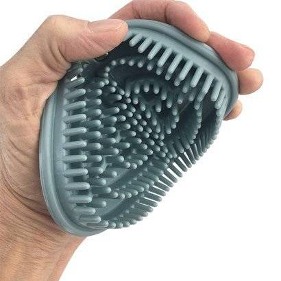 Flexible Glossy Groomer by Epona being bent in hand, showcasing its flexibility and soft rubber bristles for effective horse care.