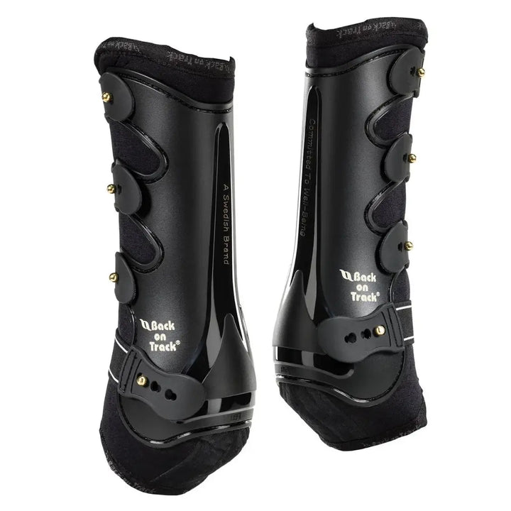 Black Royal Dressage Front Boots by Back On Track with durable straps and sleek design for therapeutic horse leg support.